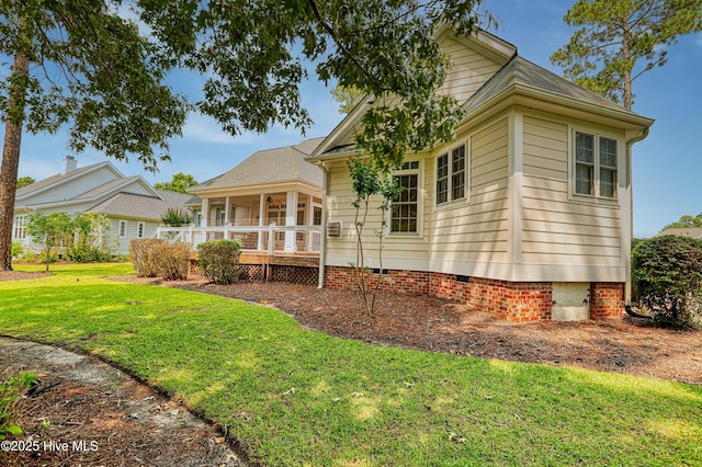 1711 Heather Run Ct SE, Bolivia, NC 28422 - view of side of home with crawl space, a lawn, and a sunroom
