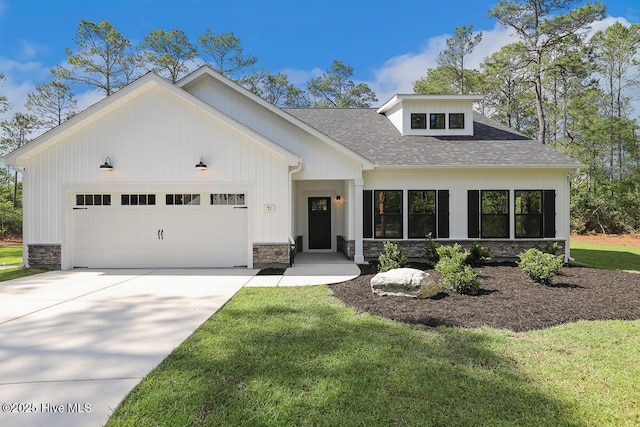 189 Craven Ct, Calabash, NC 28467 - modern farmhouse style home featuring stone siding, an attached garage, concrete driveway, and a shingled roof