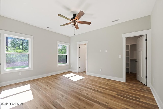 189 Craven Ct, Calabash, NC 28467 - unfurnished bedroom with baseboards, wood finished floors, and a spacious closet