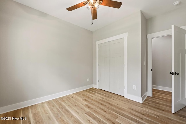 189 Craven Ct, Calabash, NC 28467 - unfurnished bedroom featuring light wood finished floors, baseboards, a closet, and a ceiling fan