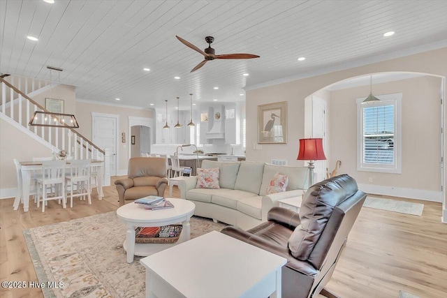 209 S 11th St, Morehead City, NC 28557 - living room with arched walkways, wood ceiling, a ceiling fan, ornamental molding, and stairway