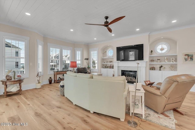 209 S 11th St, Morehead City, NC 28557 - living area featuring light wood-style floors, ornamental molding, a ceiling fan, a fireplace, and baseboards