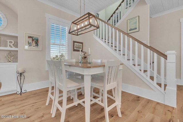209 S 11th St, Morehead City, NC 28557 - dining space featuring wood finished floors, ornamental molding, stairs, baseboards, and a chandelier