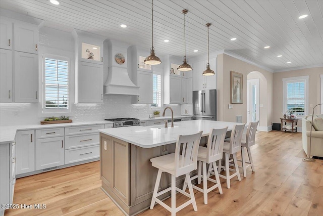 209 S 11th St, Morehead City, NC 28557 - kitchen with stainless steel appliances, a sink, arched walkways, wooden ceiling, and healthy amount of natural light
