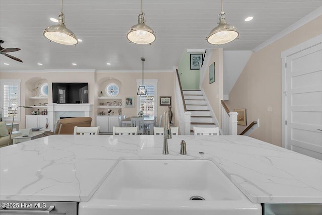 209 S 11th St, Morehead City, NC 28557 - kitchen featuring open floor plan, crown molding, light stone countertops, hanging light fixtures, and a ceiling fan