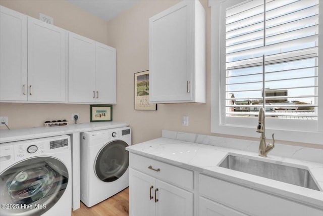 209 S 11th St, Morehead City, NC 28557 - laundry room with cabinet space, washer and dryer, and light wood-type flooring