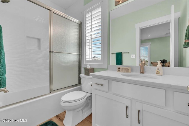 209 S 11th St, Morehead City, NC 28557 - bathroom with vanity, toilet, wood finished floors, and shower / bath combination with glass door