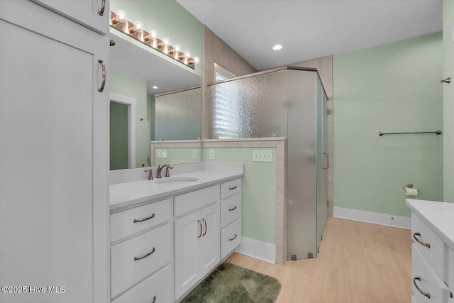 209 S 11th St, Morehead City, NC 28557 - bathroom with vanity, a shower stall, wood finished floors, baseboards, and recessed lighting