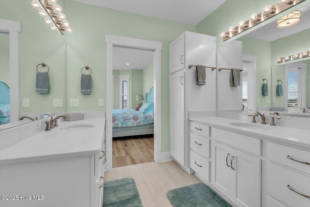 209 S 11th St, Morehead City, NC 28557 - ensuite bathroom featuring two vanities and wood finished floors