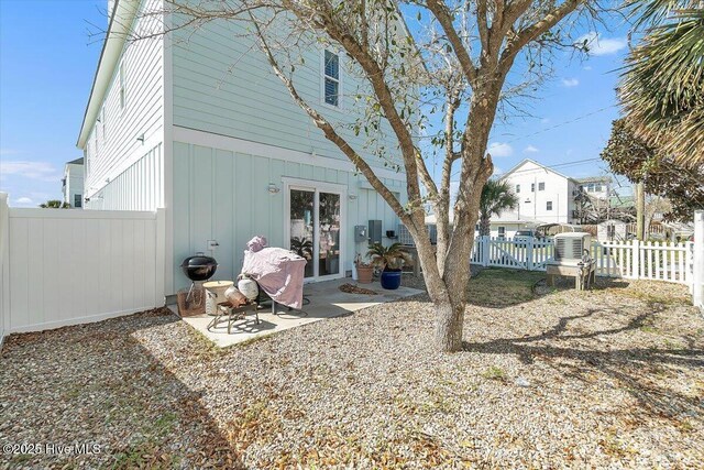 209 S 11th St, Morehead City, NC 28557 - rear view of property featuring a fenced backyard, board and batten siding, and a patio area