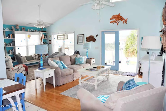 108 W Dolphin Dr, Oak Island, NC 28465 - living area with ceiling fan, plenty of natural light, light wood-style floors, and high vaulted ceiling