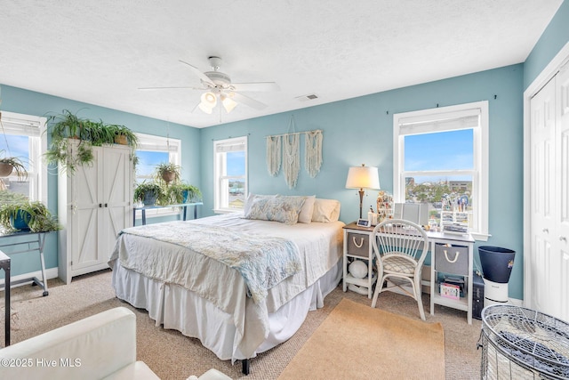 208 Carolina Beach Ave S Unit 202, Carolina Beach, NC 28428 - bedroom with light carpet, a closet, a textured ceiling, ceiling fan, and baseboards