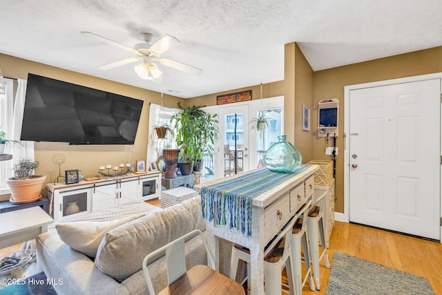208 Carolina Beach Ave S Unit 202, Carolina Beach, NC 28428 - living area with light wood-type flooring, a ceiling fan, a textured ceiling, and baseboards