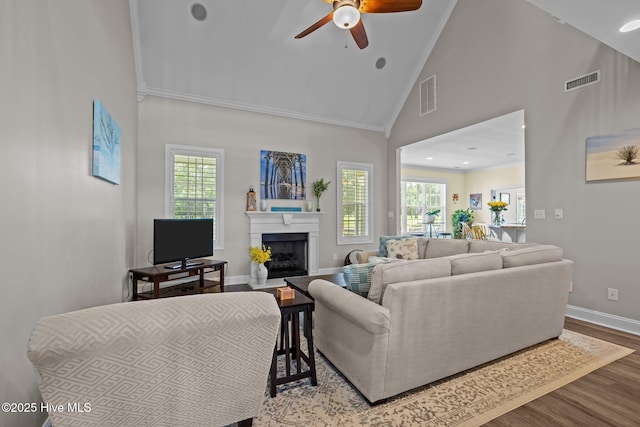 110 Gemini Dr, Cape Carteret, NC 28584 - living room with ceiling fan, wood finished floors, a fireplace, high vaulted ceiling, and crown molding