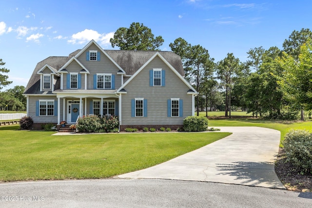 110 Gemini Dr, Cape Carteret, NC 28584 - traditional-style home featuring driveway, a porch, and a front yard