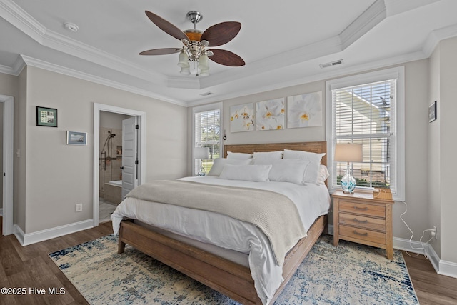 110 Gemini Dr, Cape Carteret, NC 28584 - bedroom with a tray ceiling, crown molding, wood finished floors, connected bathroom, and a ceiling fan