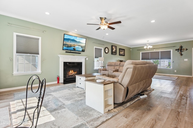 412 Palisades Way, New Bern, NC 28560 - living area with a fireplace with flush hearth, ornamental molding, light wood finished floors, ceiling fan, and baseboards