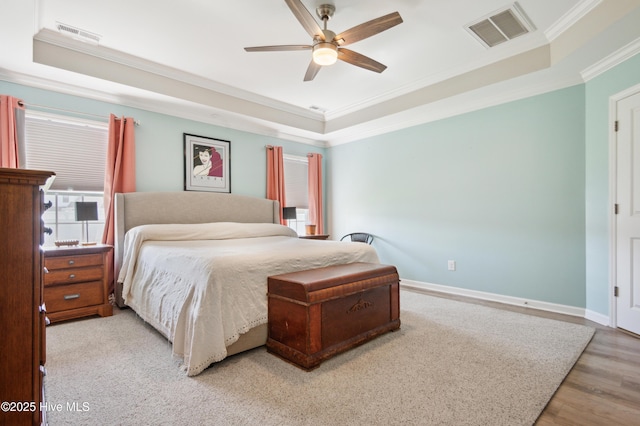 412 Palisades Way, New Bern, NC 28560 - bedroom featuring a tray ceiling, ornamental molding, wood finished floors, baseboards, and a ceiling fan