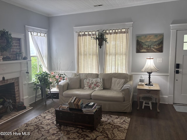 314 Ave B, New Bern, NC 28560 - living room with a wainscoted wall, wood finished floors, crown molding, and a brick fireplace