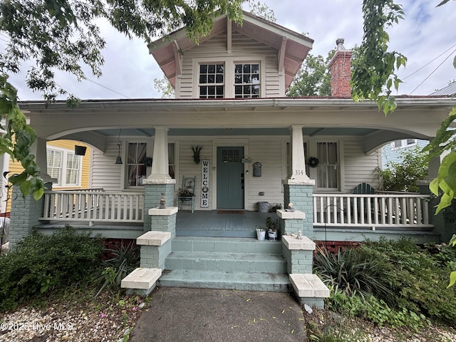 314 Ave B, New Bern, NC 28560 - view of front of home with covered porch and a chimney