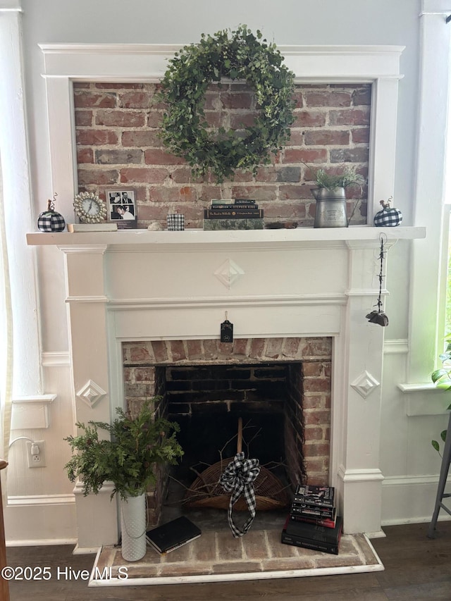 314 Ave B, New Bern, NC 28560 - detailed view of a brick fireplace, wood finished floors, and a decorative wall