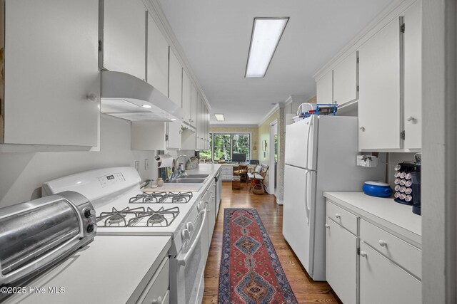103 Camelia Dr, Washington, NC 27889 - kitchen with white appliances, a sink, light countertops, wood finished floors, and ornamental molding