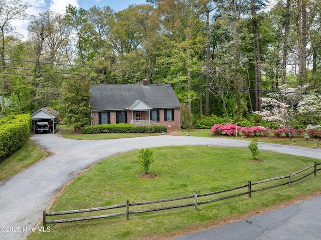 103 Camelia Dr, Washington, NC 27889 - view of front facade featuring curved driveway, a carport, a chimney, and brick siding