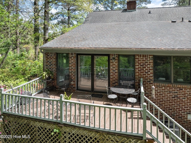 103 Camelia Dr, Washington, NC 27889 - rear view of property with brick siding, roof with shingles, a wooden deck, and a chimney
