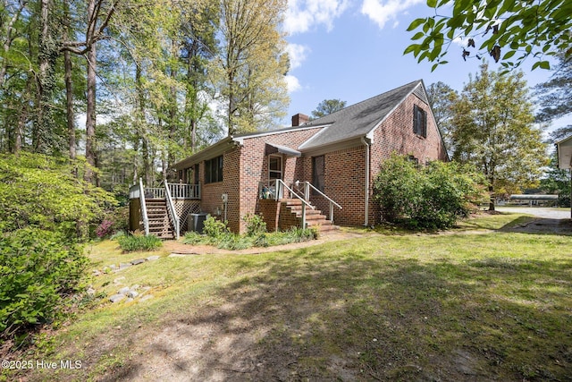 103 Camelia Dr, Washington, NC 27889 - view of front of house with brick siding, stairs, a chimney, a front yard, and cooling unit