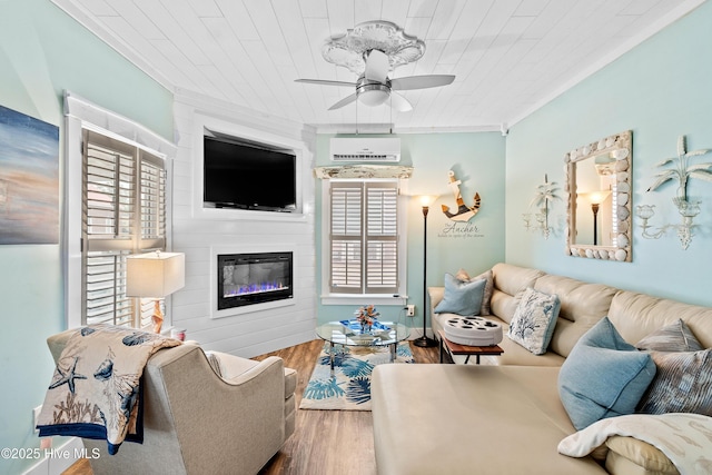 209 W St George St, Southport, NC 28461 - living area with a ceiling fan, ornamental molding, a large fireplace, wood finished floors, and a wall mounted air conditioner
