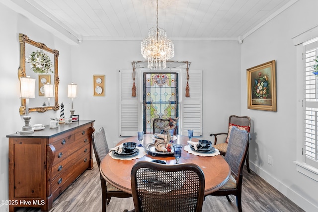 209 W St George St, Southport, NC 28461 - dining space featuring wood finished floors, a chandelier, ornamental molding, and baseboards