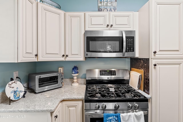 209 W St George St, Southport, NC 28461 - kitchen with stainless steel appliances and white cabinetry