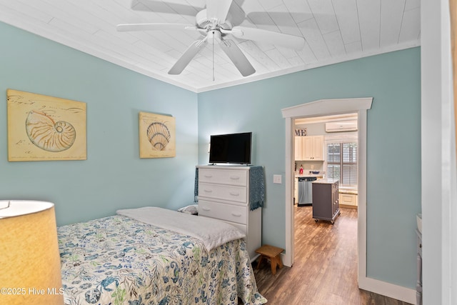 209 W St George St, Southport, NC 28461 - bedroom with a wall unit AC, wood finished floors, and ceiling fan