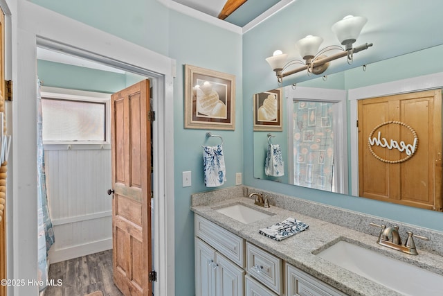 209 W St George St, Southport, NC 28461 - full bath with double vanity, wood finished floors, ornamental molding, and a chandelier