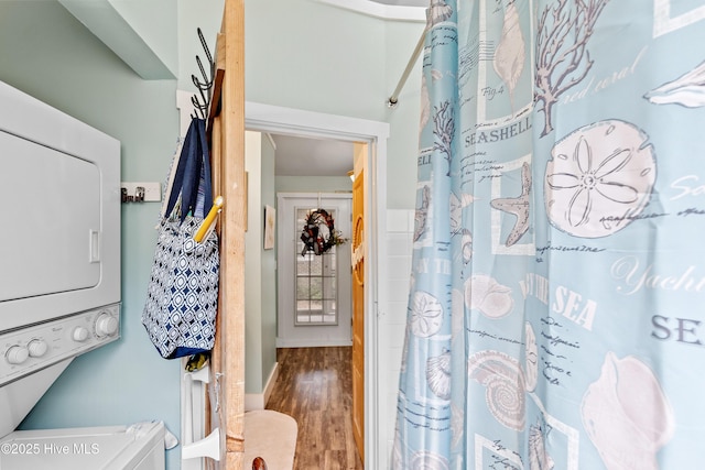 209 W St George St, Southport, NC 28461 - full bathroom featuring stacked washer and clothes dryer, wood finished floors, and a shower with shower curtain