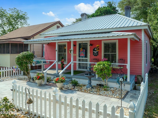 209 W St George St, Southport, NC 28461 - view of front of property featuring covered porch and metal roof