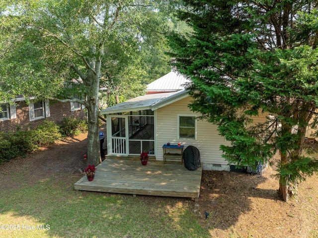 209 W St George St, Southport, NC 28461 - back of property with crawl space, a sunroom, a deck, and metal roof
