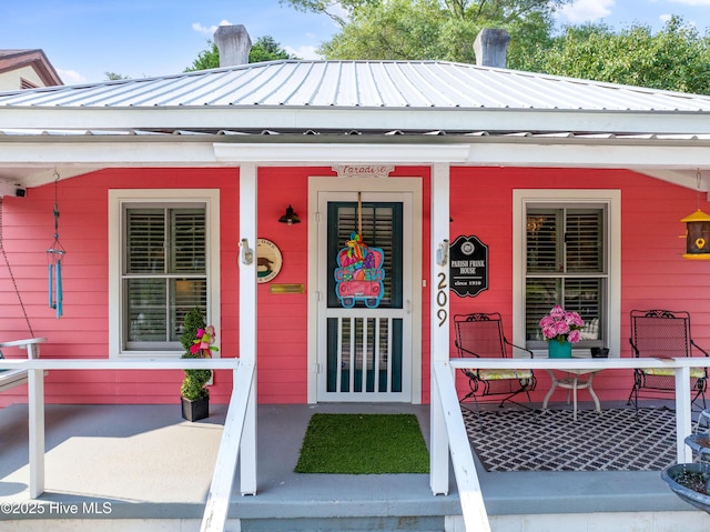 209 W St George St, Southport, NC 28461 - entrance to property featuring covered porch and metal roof