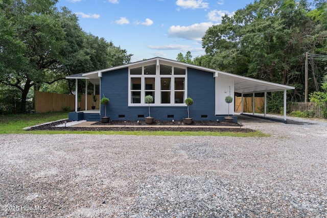 5302 Autumn Dr, Wilmington, NC 28409 - mid-century inspired home featuring crawl space, gravel driveway, and a carport