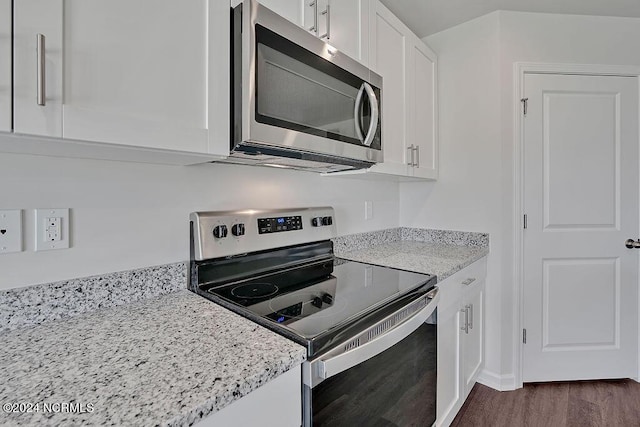 246 Kite Cir NE Lot 667, Bolivia, NC 28422 - kitchen with appliances with stainless steel finishes, white cabinetry, dark wood finished floors, light stone counters, and baseboards