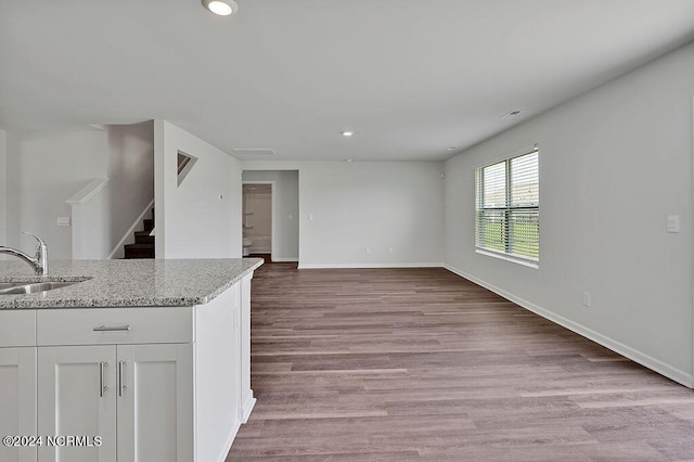 246 Kite Cir NE Lot 667, Bolivia, NC 28422 - unfurnished living room with a sink, recessed lighting, light wood-style flooring, stairs, and baseboards