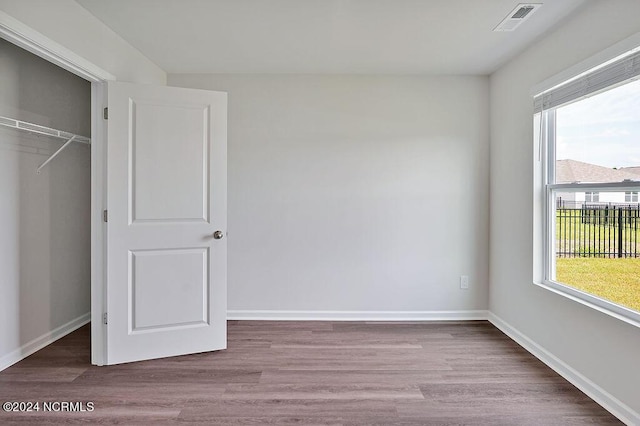 246 Kite Cir NE Lot 667, Bolivia, NC 28422 - unfurnished bedroom with multiple windows, wood finished floors, and baseboards