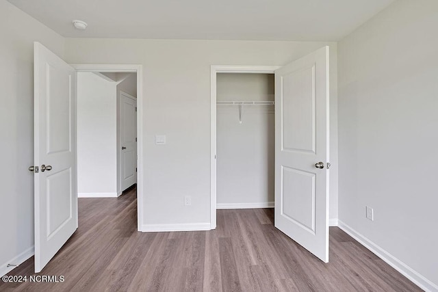 246 Kite Cir NE Lot 667, Bolivia, NC 28422 - unfurnished bedroom with wood finished floors, baseboards, and a closet