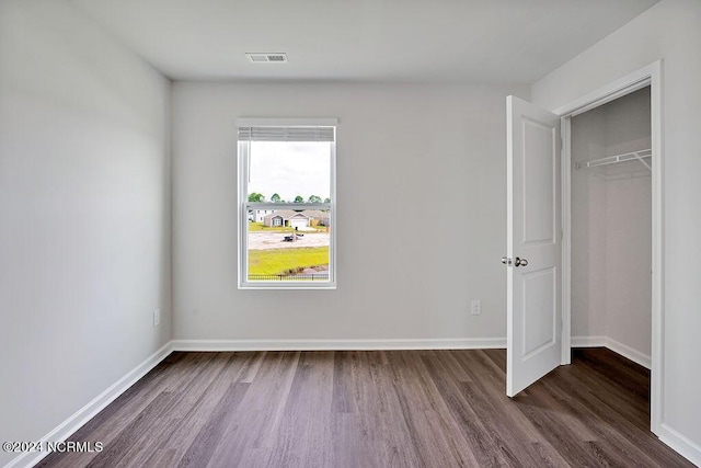 246 Kite Cir NE Lot 667, Bolivia, NC 28422 - unfurnished bedroom with dark wood-style floors, a closet, and baseboards