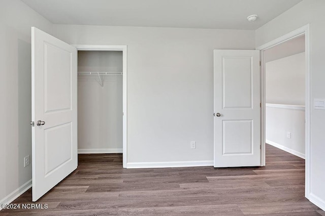 246 Kite Cir NE Lot 667, Bolivia, NC 28422 - unfurnished bedroom with wood finished floors, a closet, and baseboards