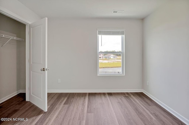 246 Kite Cir NE Lot 667, Bolivia, NC 28422 - unfurnished bedroom with wood finished floors, baseboards, and a closet