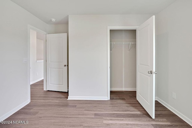 246 Kite Cir NE Lot 667, Bolivia, NC 28422 - unfurnished bedroom featuring a closet, wood finished floors, and baseboards