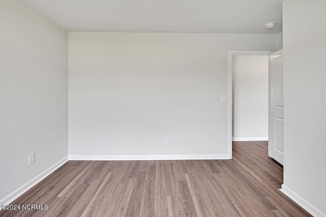 246 Kite Cir NE Lot 667, Bolivia, NC 28422 - spare room with wood finished floors, a smoke detector, and baseboards