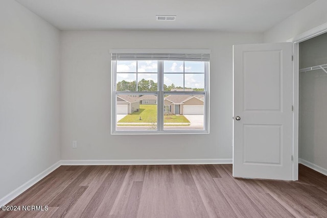 246 Kite Cir NE Lot 667, Bolivia, NC 28422 - unfurnished bedroom with wood finished floors, baseboards, and a closet