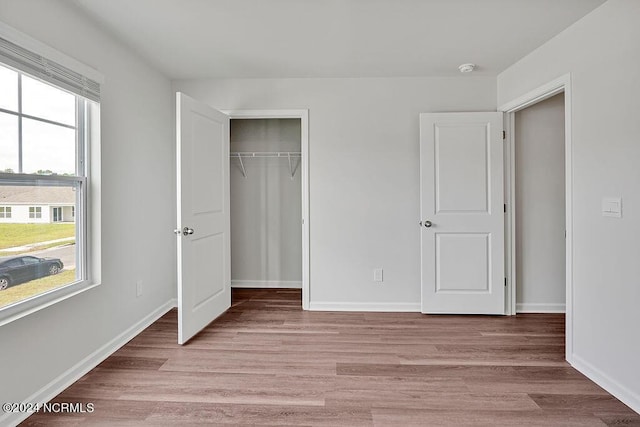 246 Kite Cir NE Lot 667, Bolivia, NC 28422 - unfurnished bedroom featuring light wood-type flooring, a closet, and baseboards